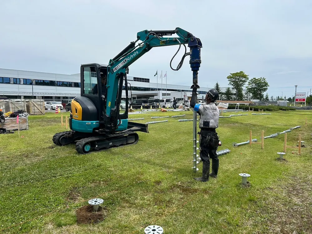 Precision ground screw installation for a large-scale solar farm in Chitose, Japan, featuring SR Solar high-durability mounting hardware