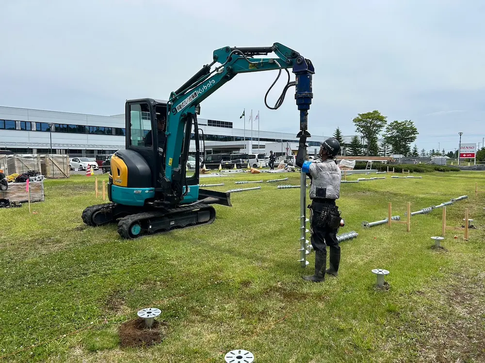 Precision ground screw installation for a large-scale solar farm in Chitose, Japan, featuring SR Solar high-durability mounting hardware