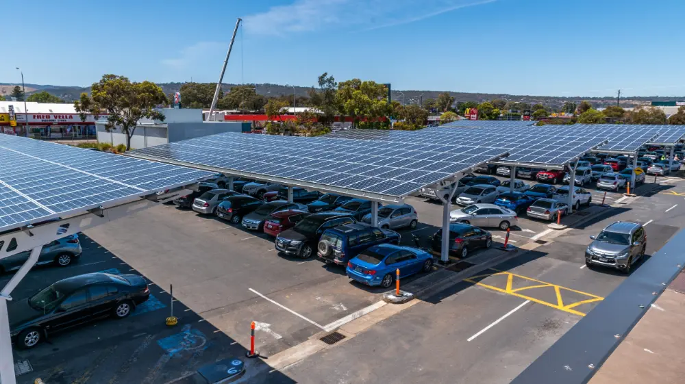 Commercial solar carport mounting system featuring SR Solar single-pole aluminum structure for large-scale parking lot projects