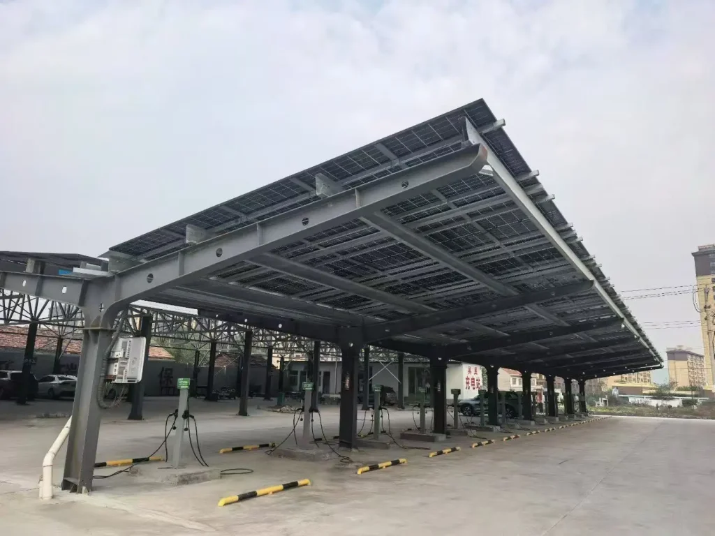 Heavy-duty steel solar carport structure under installation by SR Solar manufacturer factory in China.