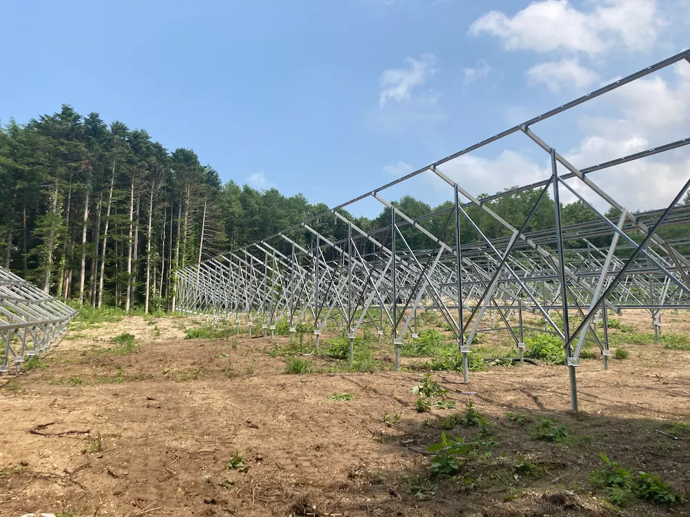 Heavy-duty aluminum ground mounting system with ground screws for a utility-scale solar project in Hokkaido, Japan, manufactured by SR Solar.