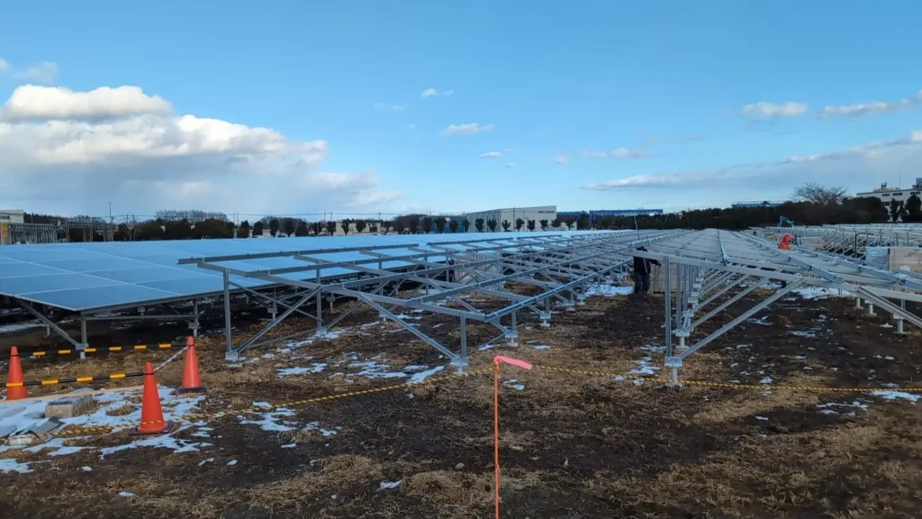 Open steel ground mounting structure racks under construction for a utility solar farm in Tochigi, Japan
