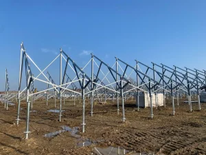 Heavy-duty SR Solar ground mount steel frame structures being erected on ground screw foundations during the project construction phase.
