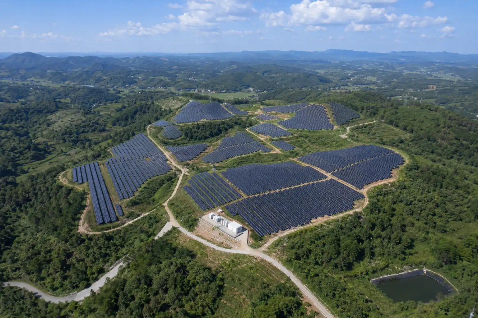 Aerial view of a large-scale hillside solar farm utilizing SR Solar ground mounting systems, engineered by a leading OEM/ODM manufacturer for complex terrains.