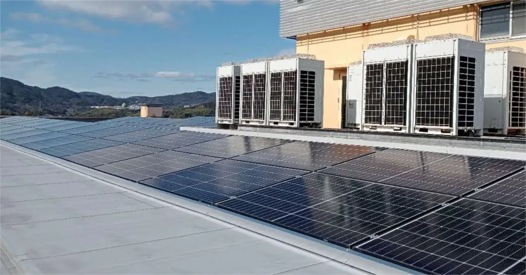 SR Solar waterproof flat roof triangle solar racking system integrated beside HVAC units for a Japan project.