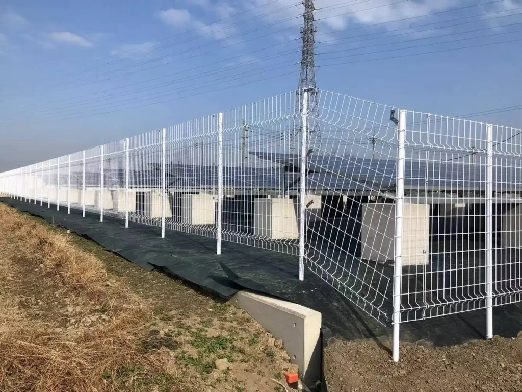 An expansive view of a solar farm utilizing SR Solar cement foundation racking systems with secure perimeter fencing for utility-scale security.