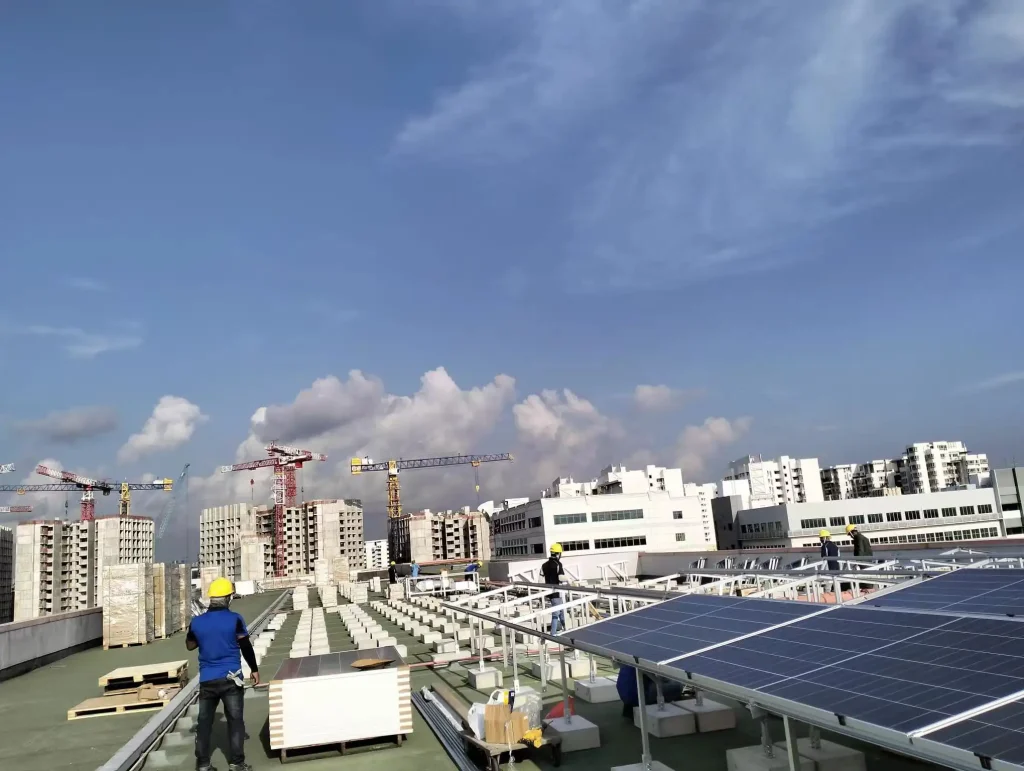 Large-scale commercial rooftop solar project under construction in Singapore utilizing SR Solar concrete ballast racking infrastructure.