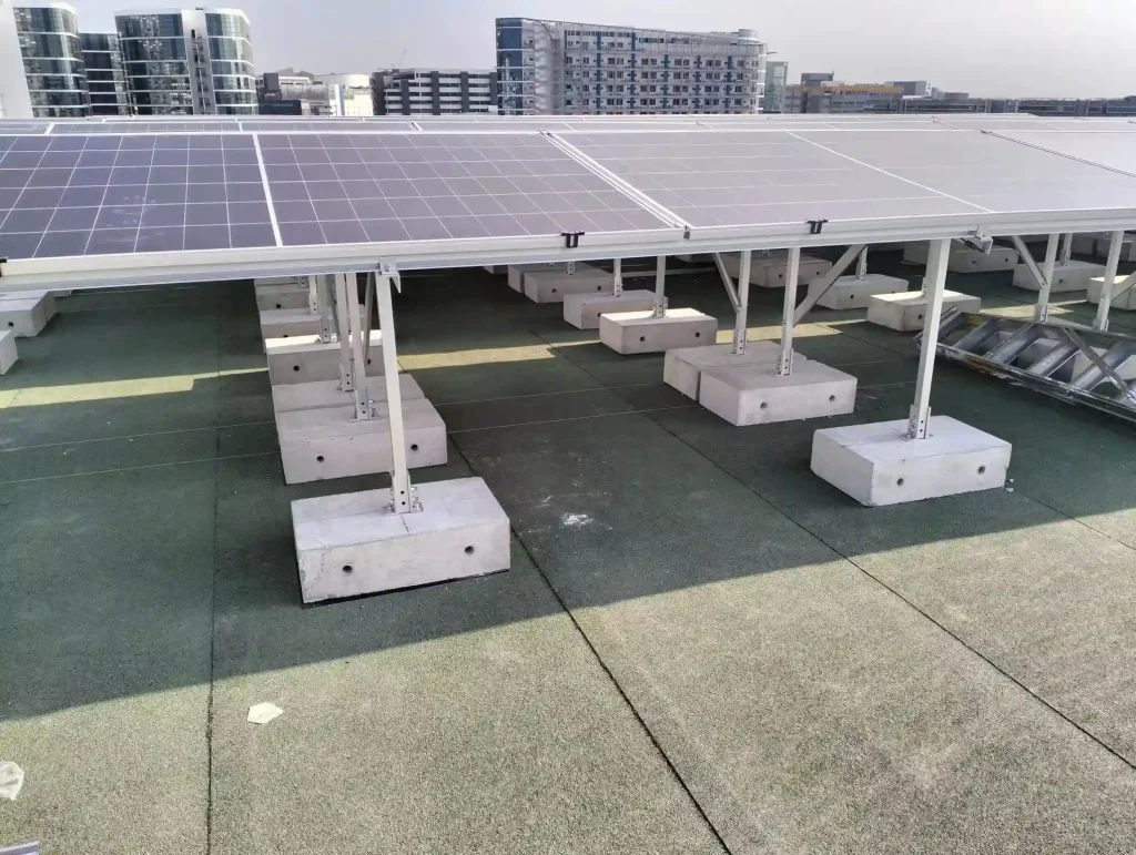 Non-penetrating flat roof ballast solar mounting solutions engineered by SR Solar on precast concrete blocks in Singapore.