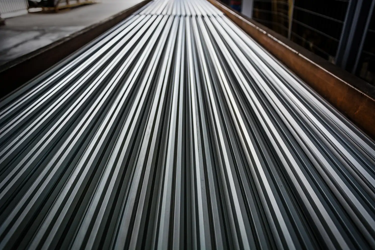 Anodized aluminum solar mounting rails stacked neatly inside the SR Solar manufacturing factory for global wholesale supply.