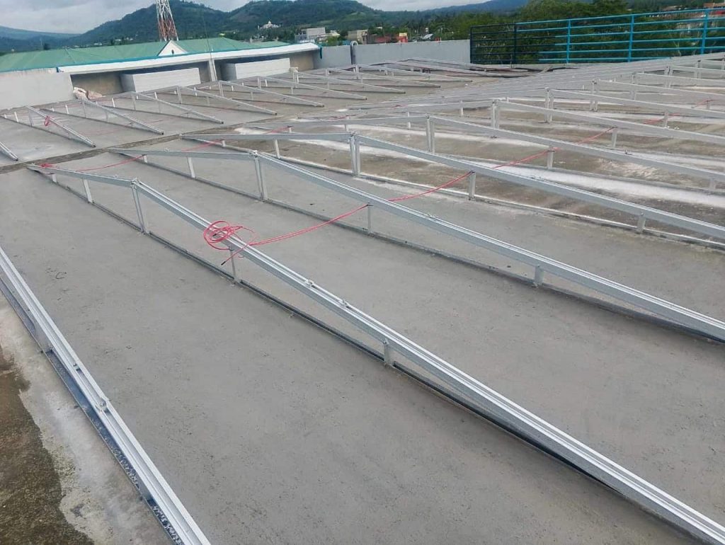 Pre-assembled structural aluminum triangle frames for solar panels manufactured by SR Solar on a flat commercial roof deck.
