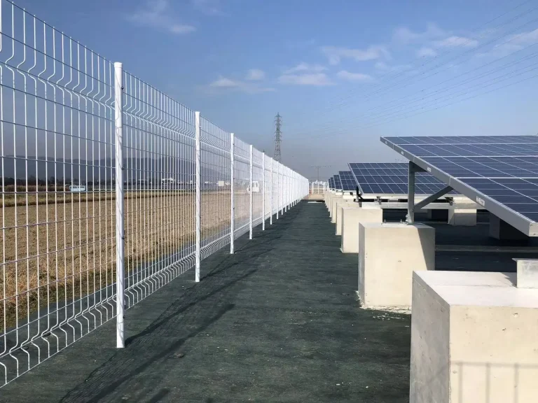 SR Solar concrete base ground mounting system installed in an open field, showcasing high-quality aluminum solar racks and secure fencing by the factory.