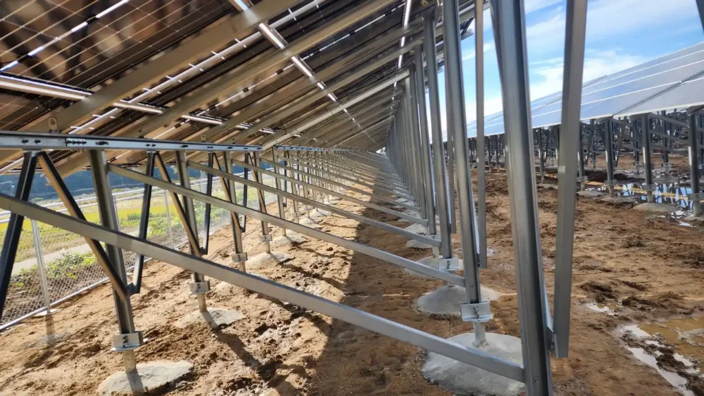 Symmetric perspective of continuous concrete reinforced foundation blocks holding SR Solar ZAM steel solar brackets.