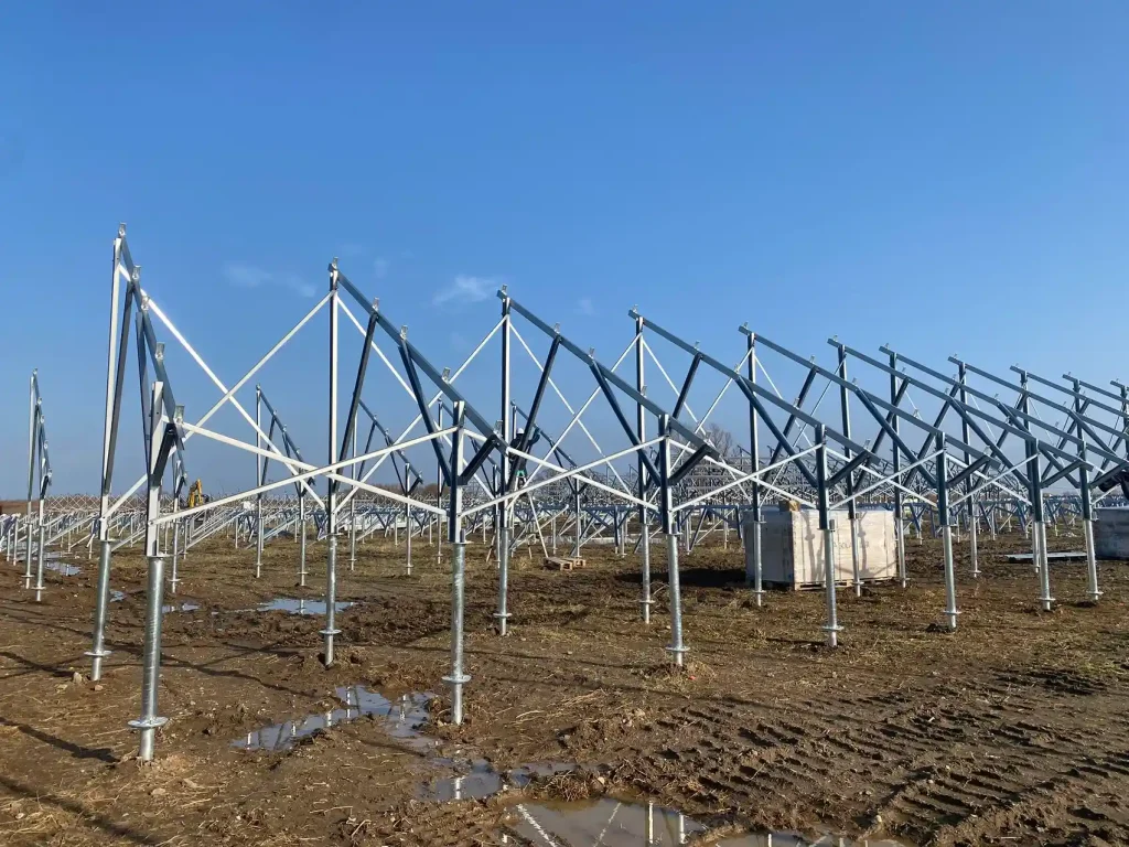 Long continuous rows of fully assembled triangular solar racking frames engineered by SR Solar on a utility site.