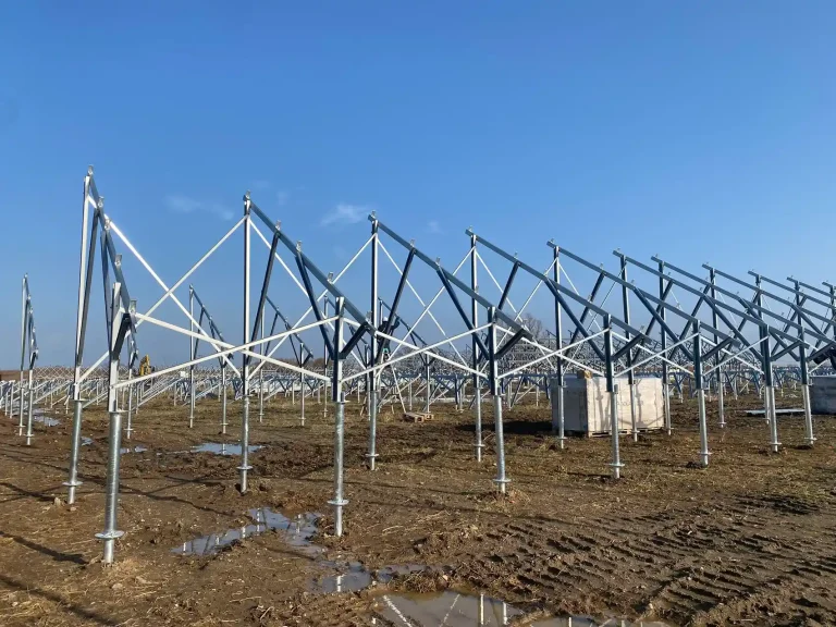 Long continuous rows of fully assembled triangular solar racking frames engineered by SR Solar on a utility site.
