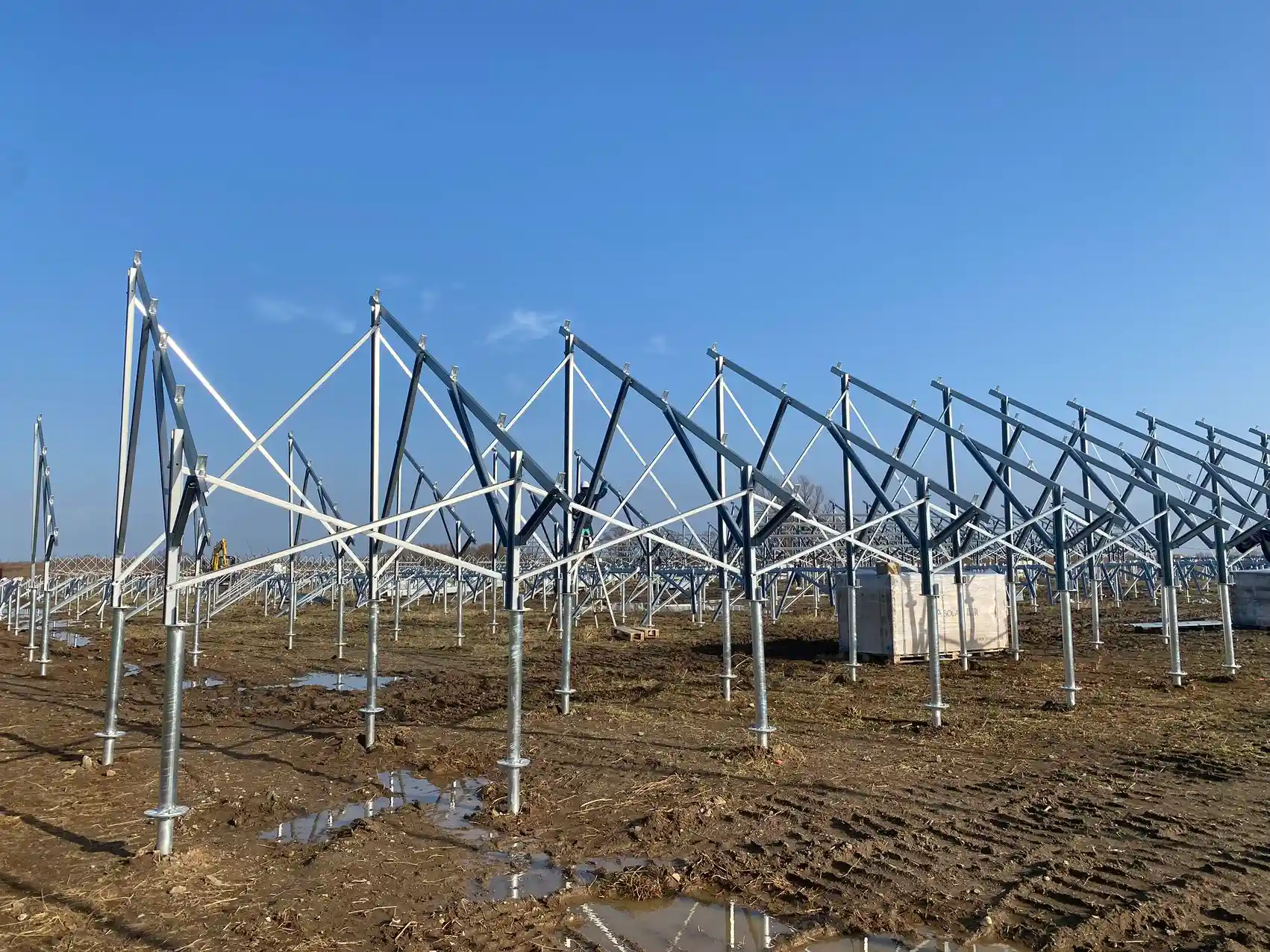 Long continuous rows of fully assembled triangular solar racking frames engineered by SR Solar on a utility site.