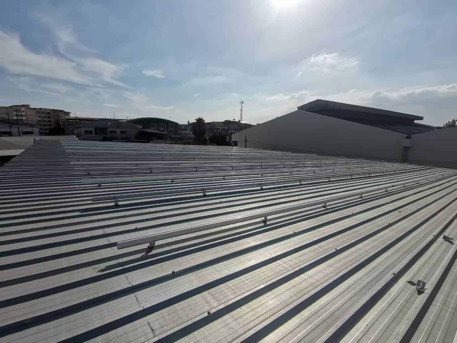 Shining anodized aluminum solar rail grid system utilizing SR Solar L-feet technology on a clean commercial metal deck.