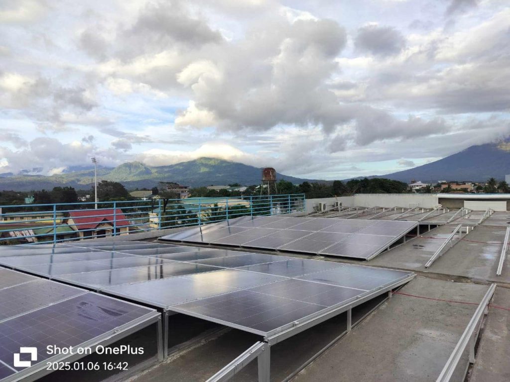 Solar panels installed on an east-west triangle aluminum bracket system by SR Solar on a flat concrete rooftop in the Philippines.