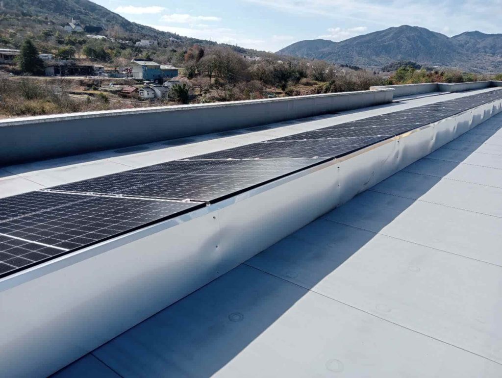 Extended linear row profile of SR Solar tripod solar racking featuring continuous protective wind deflectlector sheets