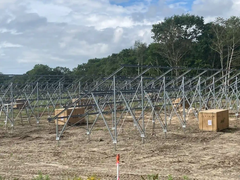 Industrial ground mounting solutions by SR Solar under construction with heavy-duty wooden packaging crates on site.