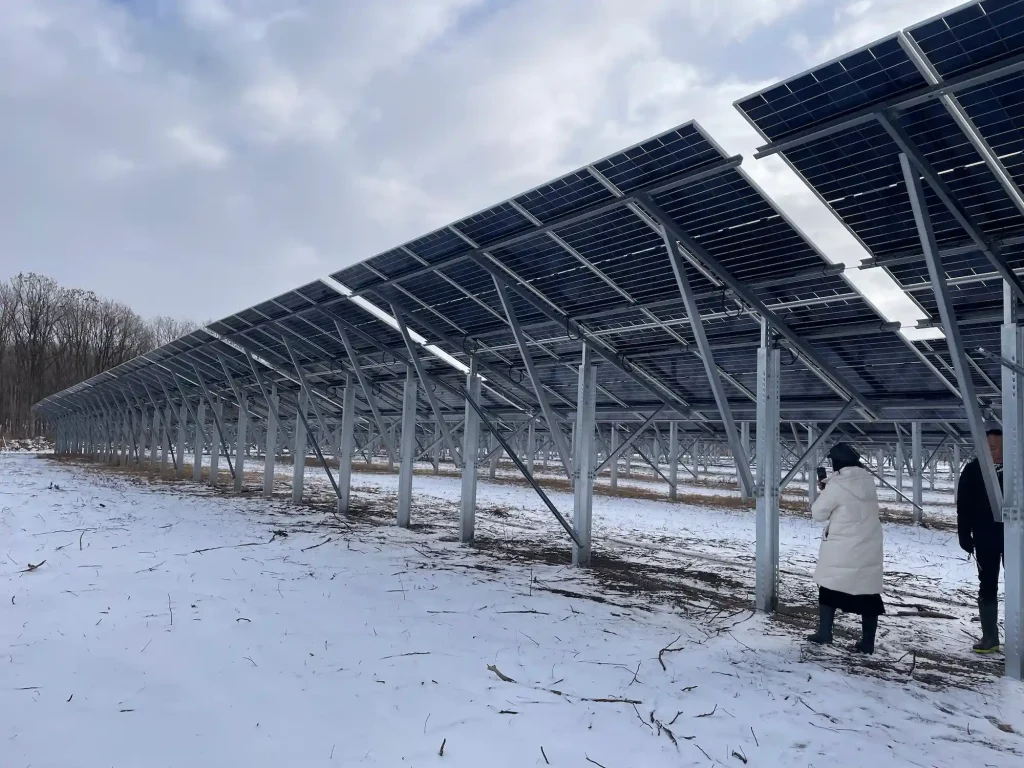 Rear view of the SR Solar high-clearance single-post solar racking system installed on a snow-covered field in Hokkaido.