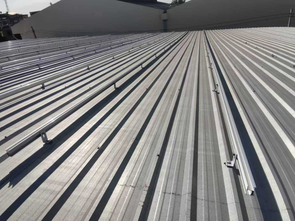 Overhead perspective of parallel lines of heavy-duty aluminum solar racking rails fixed via SR Solar L-feet kits.