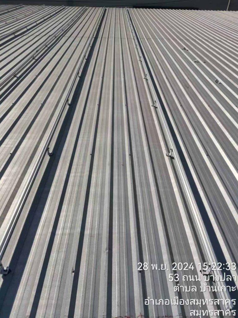 Industrial corrugated metal roof solar racking featuring rows of SR Solar aluminum rails and L-feet brackets in Thailand.