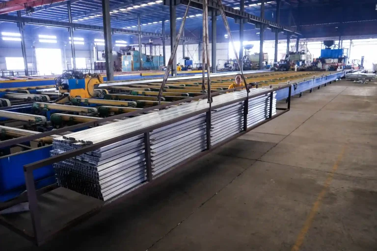 Stacks of anodized aluminum profiles moving along automated production lines inside the SR Solar manufacturing factory.