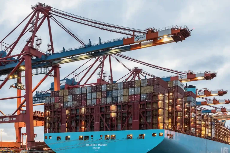 Massive container cargo ship being loaded at a major port terminal for SR Solar reliable global delivery.