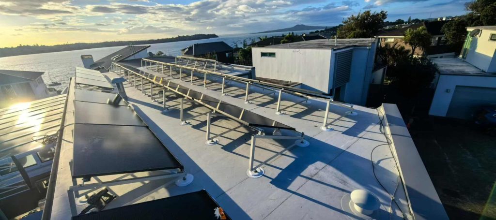 A high-angle panoramic view of SR Solar triangle solar racking system installed on a non-penetrating TPO waterproof flat roof.