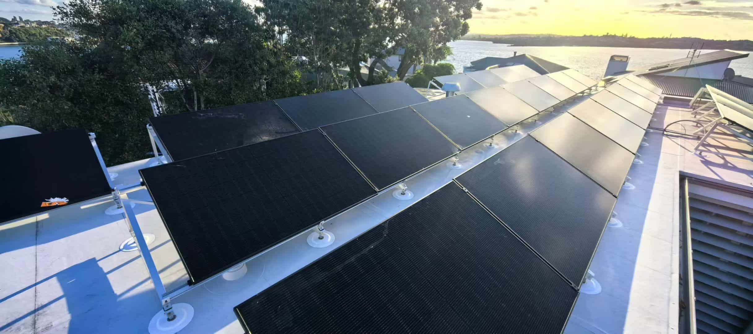 Sleek black solar panels mounted securely on SR Solar aluminum triangle racking structures over a residential TPO flat roof.