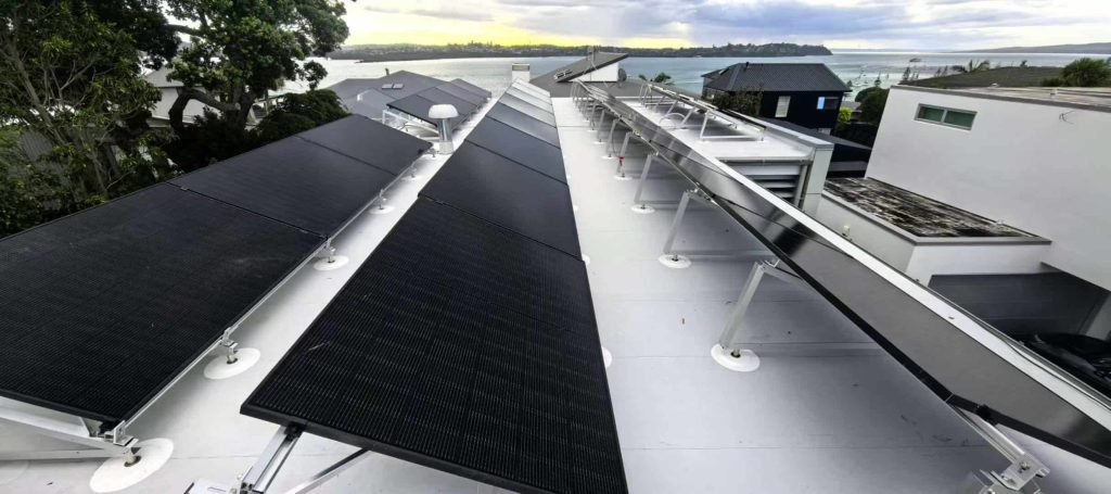 Perfectly aligned solar panel rows supported by SR Solar triangle tracking mounting structures on a light-colored TPO roof.