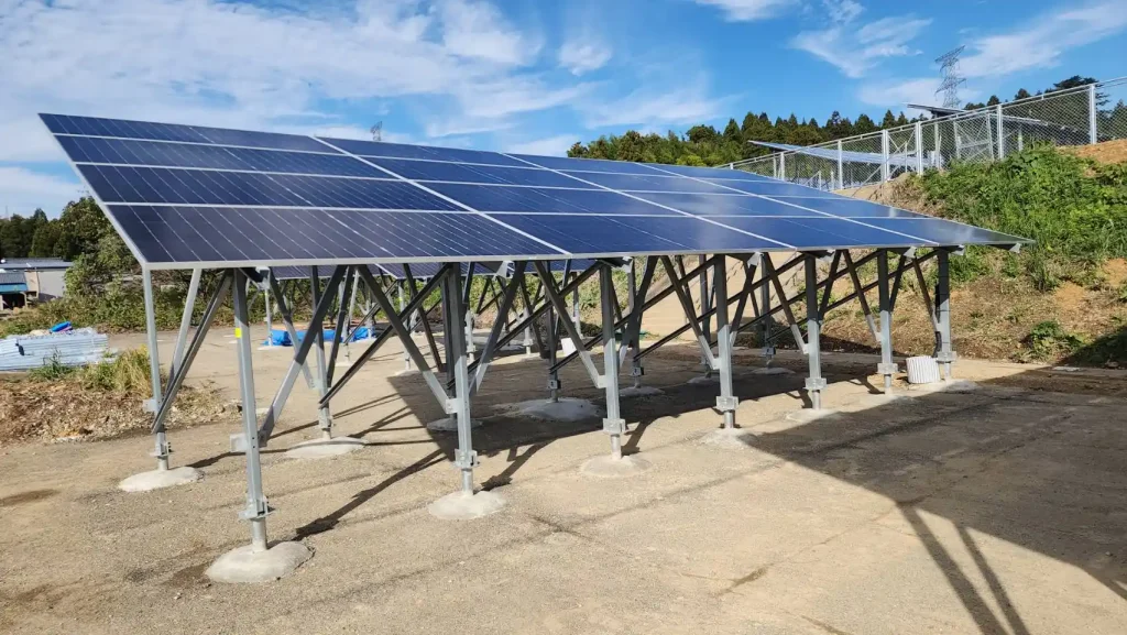 A single complete row of solar panels mounted on SR Solar ZAM steel structure with concrete reinforced foundations in Japan.