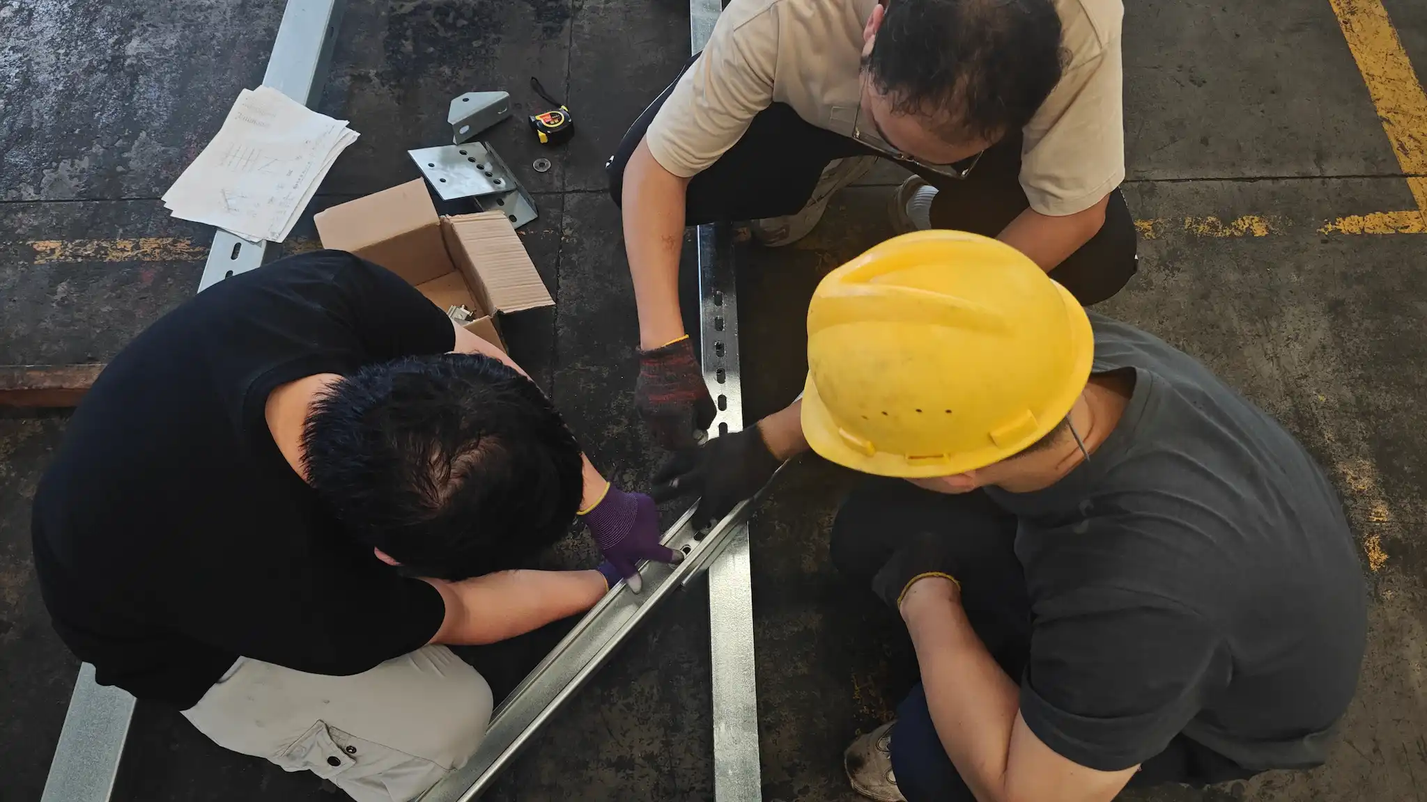 SR Solar engineers bolting and checking solar mounting channel steel in factory