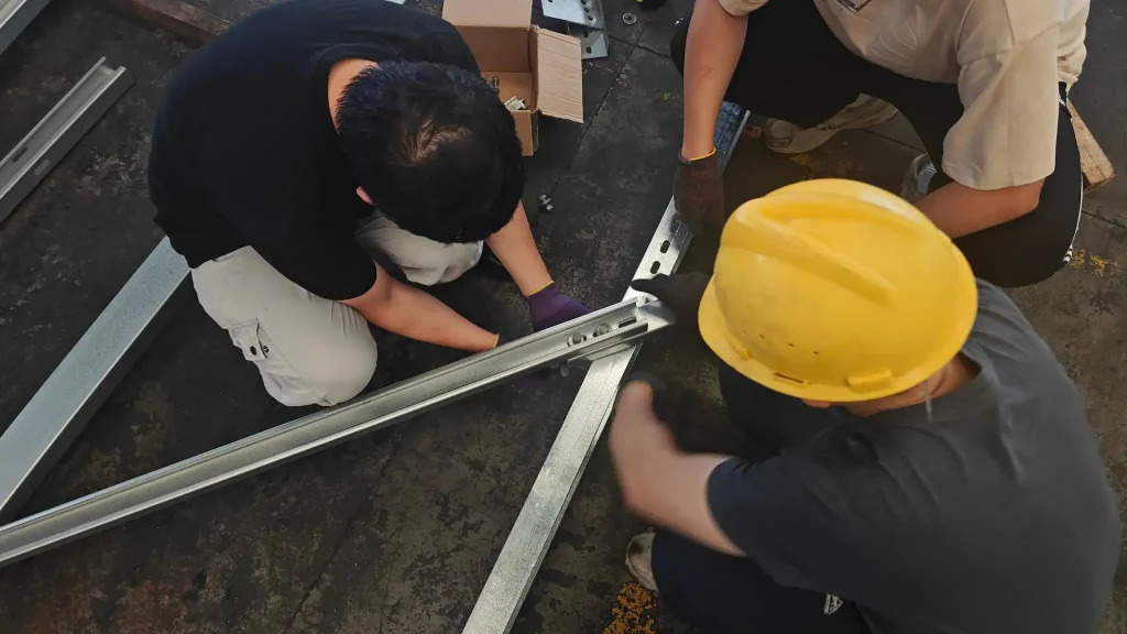 Close-up of SR Solar engineers pre-assembling solar mounting profiles in manufacturing plant