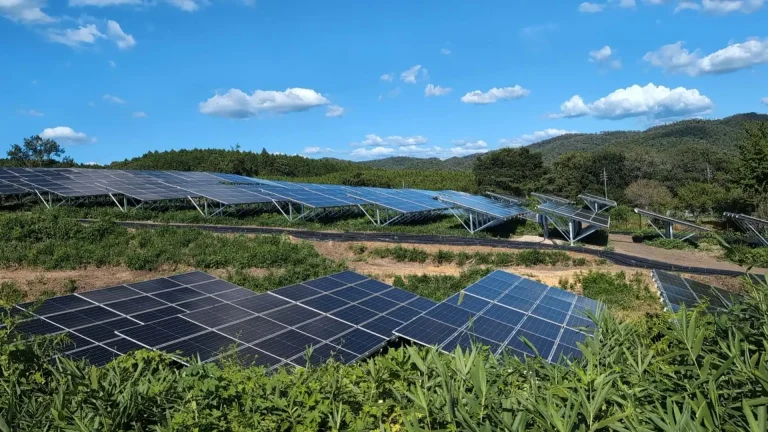 Vast solar panel array mounted on SR Solar aluminum ground structures across hillside terrain.