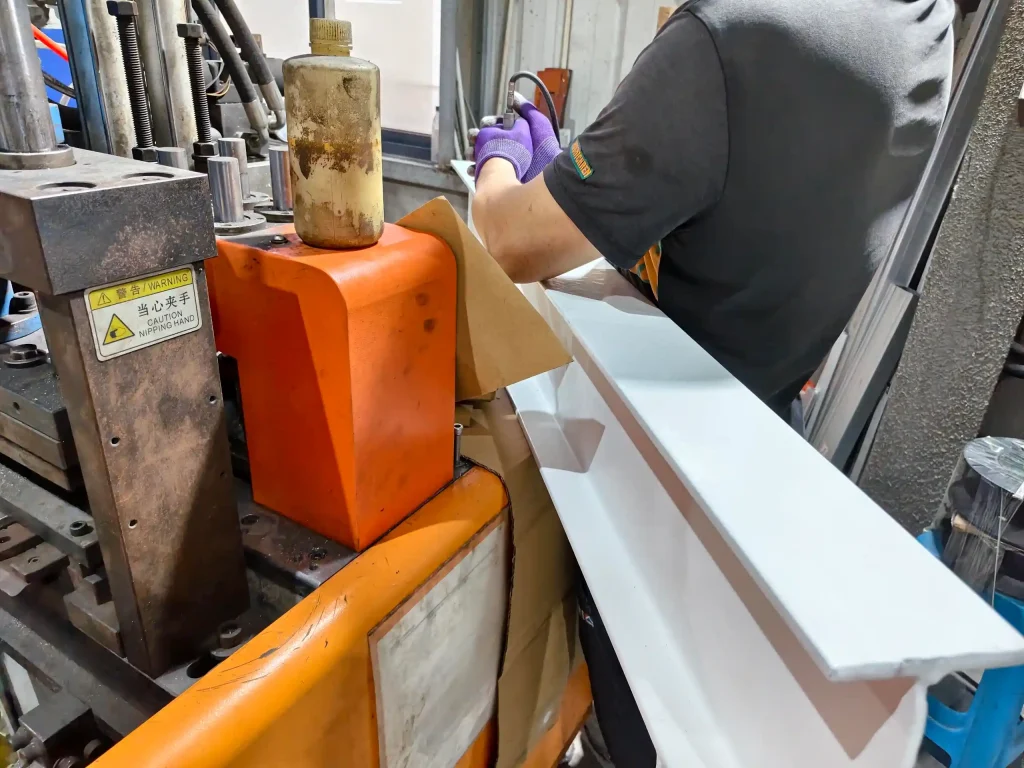 SR Solar quality control engineer inspecting coating thickness on solar mounting racking beam in factory