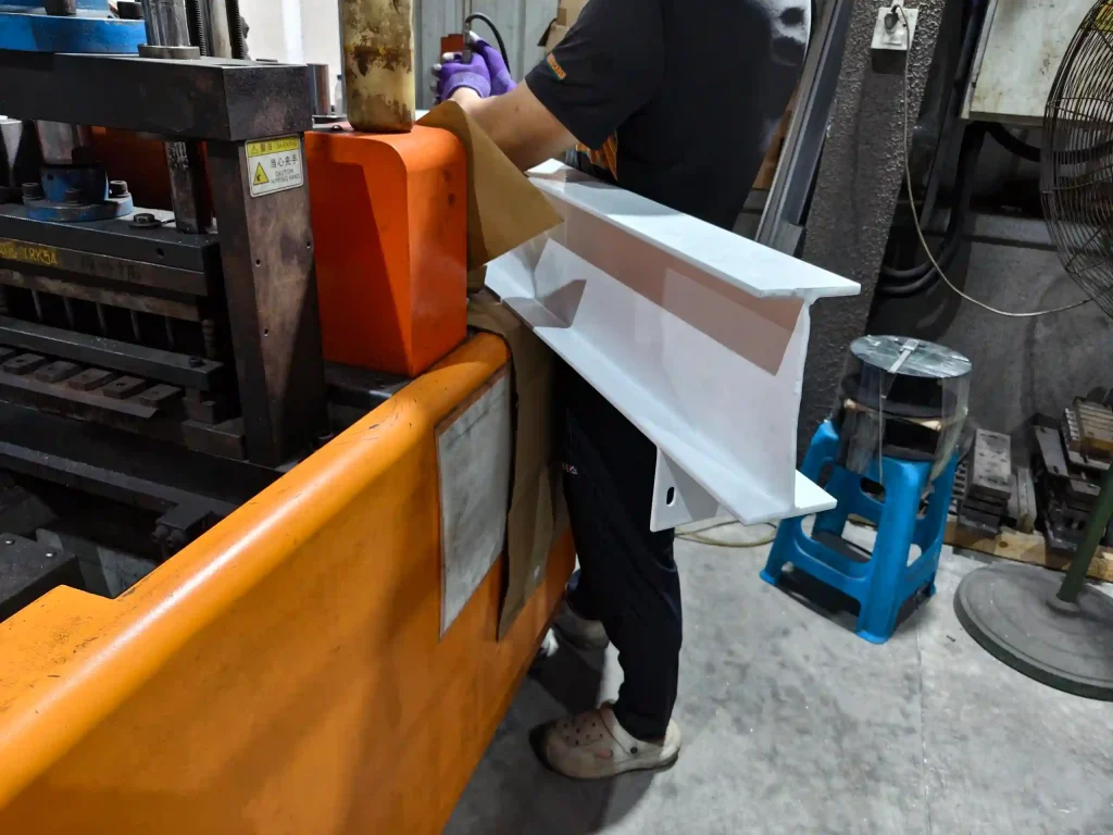 SR Solar factory technician measuring powder coating thickness on structural solar mounting beam