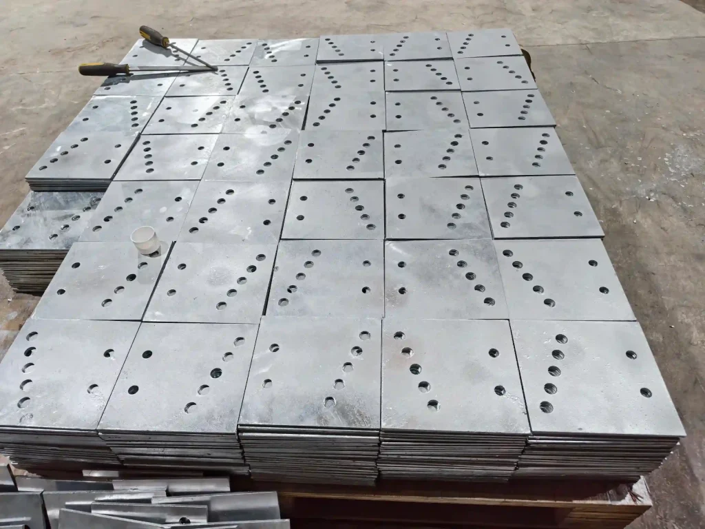 SR Solar precision-stamped steel base plates stacked in factory for mounting systems