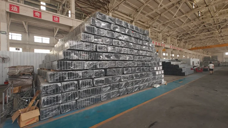 SR Solar warehouse featuring stacked bulk packages of steel solar mounting rails