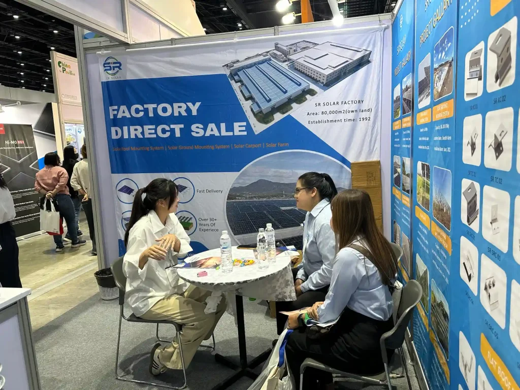 B2B solar buyers exploring SR Solar mounting structures and roof clamp displays at Thailand exhibition booth.