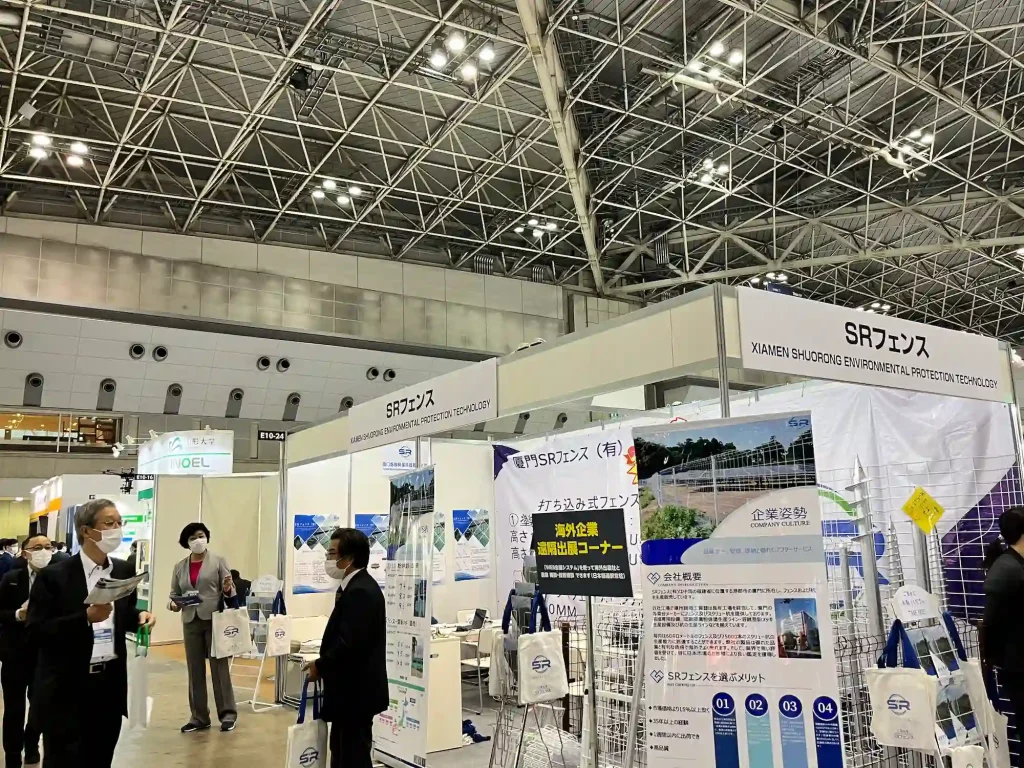 SR Solar exhibition display featuring solar mounting brackets, ground screw samples, and technical specifications at PV EXPO Japan.