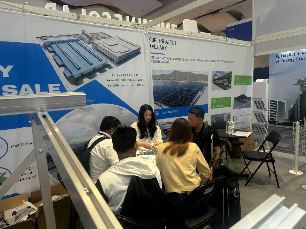 SR Solar team welcoming B2B clients at Solar and Storage Live Philippines booth 2-J10 showcasing mounting structures.