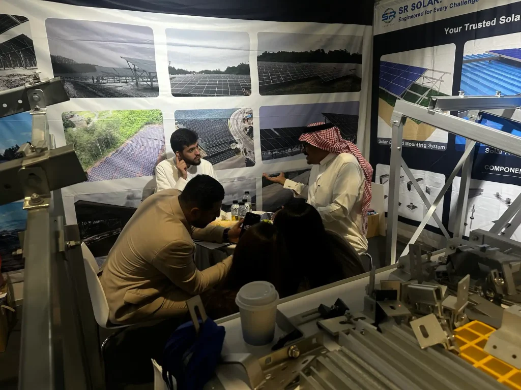 Middle Eastern solar project developers meeting with SR Solar experts to discuss ground-mounted racking systems at booth H1-H64.